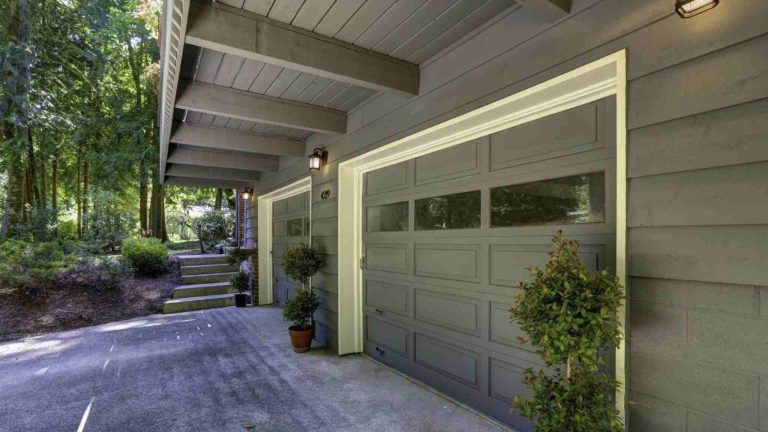 Top 7 signs your garage door needs repair: a must-read for ontario homeowners – trusted quality View from outside the home of 2 garage door.