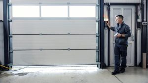 A mechanic is testing a garage door.