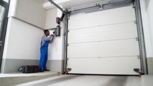 A professional is installing an automatic garage door.