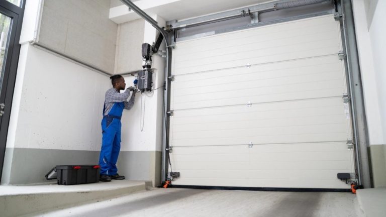 5 ways to keep your garage door running smoothly all year in mississauga – trusted quality A professional is installing an automatic garage door.