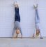 Girls doing a handstand in front of a garage door